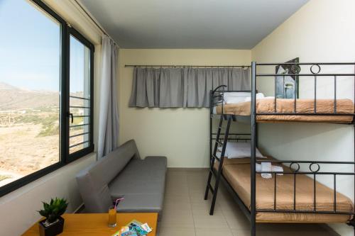 a small room with a bunk bed and a couch at Pachia Ammos Falasarna in Falasarna