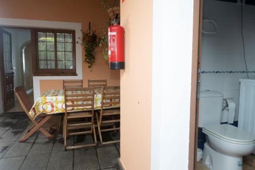 Habitación con mesa, sillas y aseo. en Casa El Correo, en Puntallana