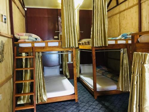 a group of bunk beds in a room at Green Hill Hostel & Tour in Ha Giang