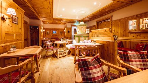 a restaurant with wooden walls and tables and chairs at Landgasthof Hotel Gentner in Nürnberg