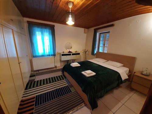 a bedroom with a large bed and a window at Radovoli in Papigko