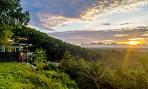 a house on a hill with a view of a forest at Ao Luek Panoramic Pool-SHA Plus in Ao Luk
