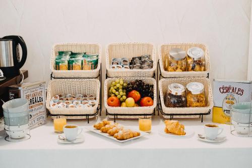 four baskets filled with different types of food on a table at Hotel La Valle dell'Aquila in LʼAquila