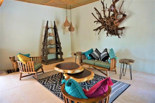 a living room with chairs and a table at Hotel Boutique La Puerta Azul Beachfront - Adults Only in Holbox Island