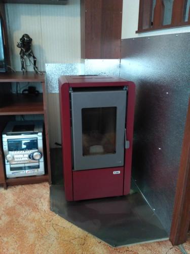 a red oven in a kitchen with a counter at ubytování na kopečku in Velké Svatoňovice