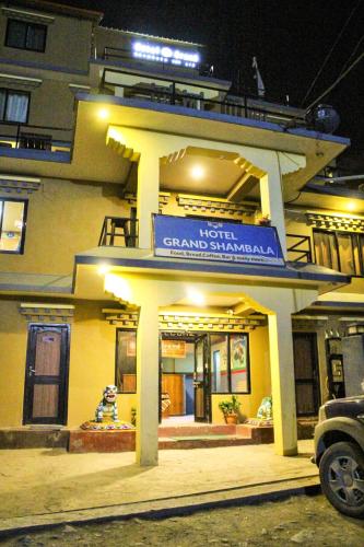 a building with a sign in front of it at Hotel Grand Shambala in Muktināth