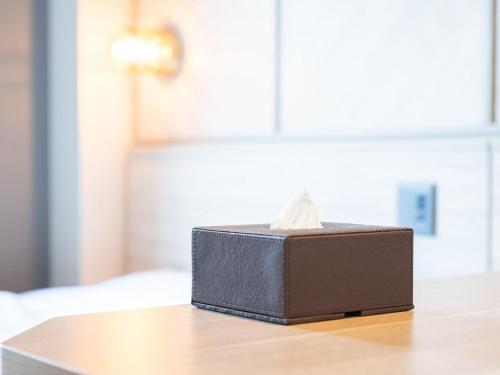 a box of tissues sitting on top of a table at SUPERHOTEL Matsumoto Oshiroguchi in Matsumoto