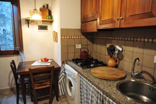 a kitchen with a sink and a stove top oven at Casa Messi in Pitigliano