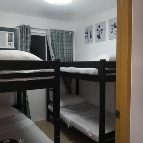 a room with two bunk beds in a bedroom at 426 Anabelle Residence at Marina Spatial Condominium in Dumaguete