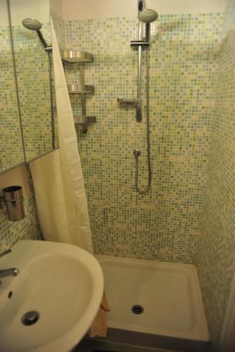 a bathroom with a shower and a sink and a tub at Casa Messi in Pitigliano