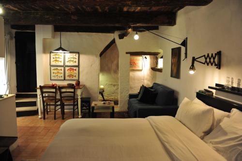 a bedroom with a bed and a living room at Casa Messi in Pitigliano