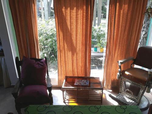 a living room with a chair and a coffee table at La casita de Pablo in Santa Teresita