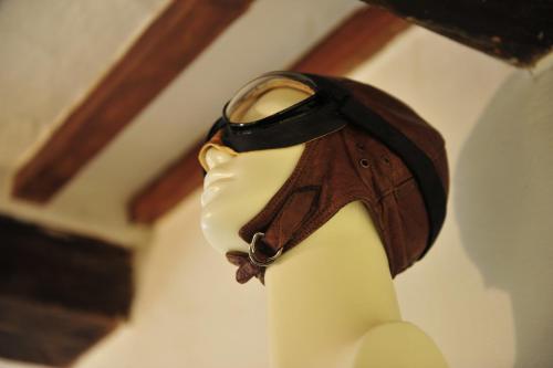 a statue of a cat wearing a leather collar at Casa Messi in Pitigliano