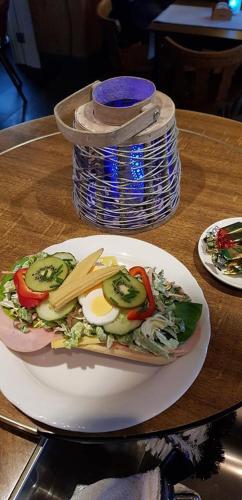 a plate of food with eggs and vegetables on a table at Hotel-Cafe Knoors-Meeks Stein Urmond in Berg
