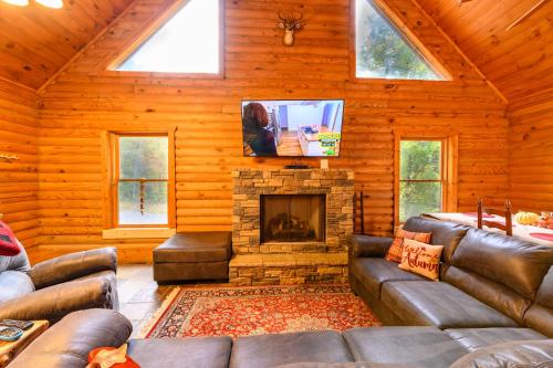 a living room with a couch and a fireplace at Smokies Overlook Lodge in Waynesville
