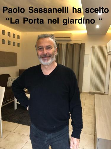 a man in a black shirt standing in a room at La Porta Nel Giardino in Asti