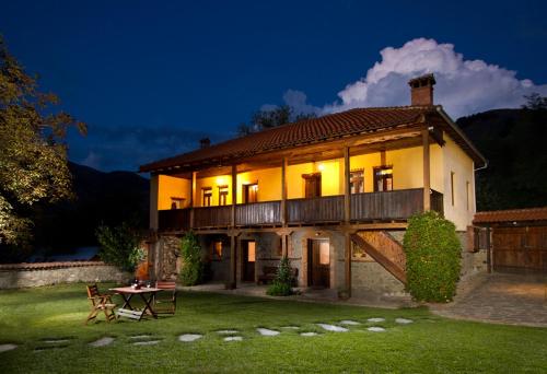 a large house with a table in the yard at Kivotos Epavlis in Prespes