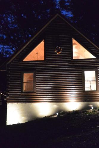 a house with lights on the side of it at night at Smokies Overlook Lodge in Waynesville