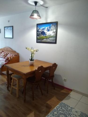 a dining room with a table and chairs and a bed at T2 RESIDENCE 3 ETOILES Piscine chauffée Sauna Hammam in Cauterets