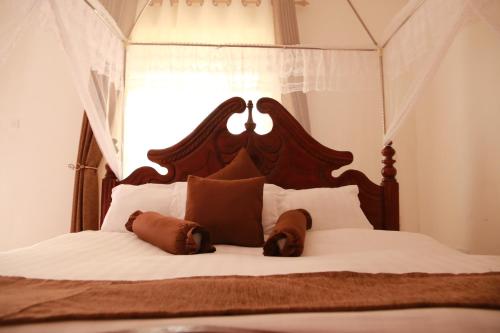 A bed or beds in a room at Riverside Resort Hotel Kabale