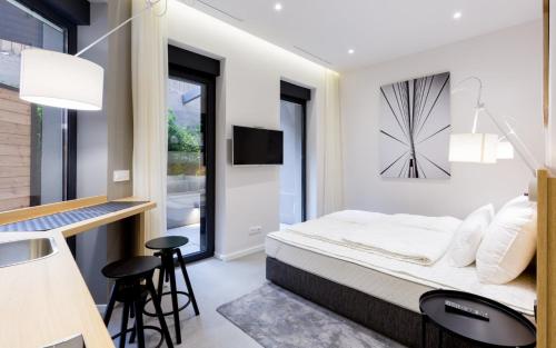 a bedroom with a bed with a clock on the wall at Teanna Lux Apartments in Belgrade