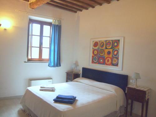 a bedroom with a bed in a room with a window at Nell'Antica Torre di Fronte a Siena in Siena