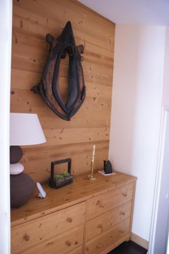 a room with a wooden wall with a dresser at Le Mazot - Avoriaz- séjours du dimanche au dimanche in Avoriaz