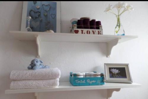 a shelf with towels and a stuffed animal on it at Marisa Home in Orzola