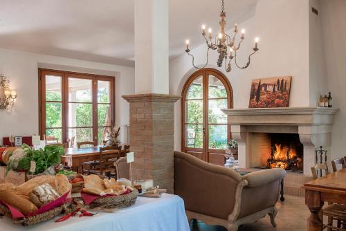 a living room with a fireplace and a table and chairs at Agriturismo Villa Toscana in Campiglia Marittima