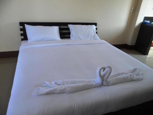 a white bed with a heart made out of towels at Jansupar Court in Chiang Rai