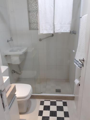 a bathroom with a shower and a toilet and a sink at Copacabana Beach Modern Apartments in Rio de Janeiro