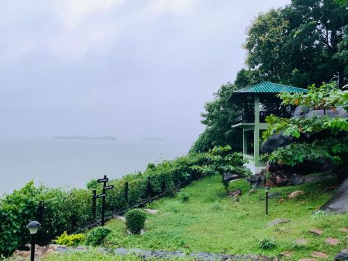 a house on the side of a hill with a fence at Diga vista resorts in Palakkad