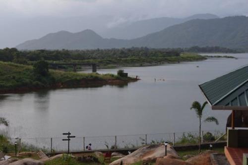 a large body of water with mountains in the background at Diga vista resorts in Palakkad