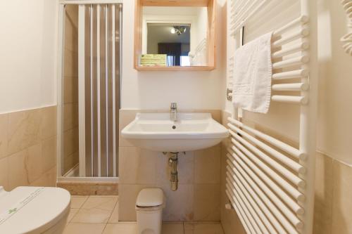 a bathroom with a sink and a toilet and a mirror at Daglingegneri in Pisa