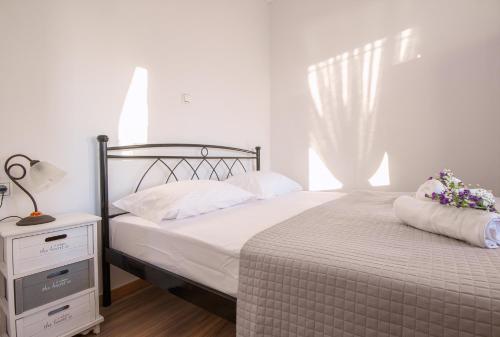 a bedroom with a bed and a window with flowers on it at CHEZ KONSTANTINOS in Kallirakhi