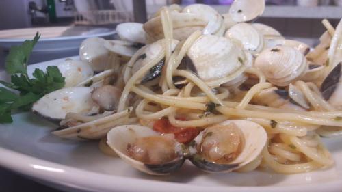 a plate of pasta with oysters and mushrooms at Hotel zum Goldenen Wagen in Maulburg