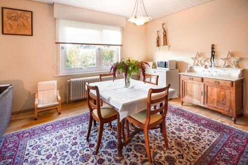 a kitchen and dining room with a table and chairs at Parkhotel in De Panne