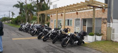a row of motorcycles parked next to a building at Hotel Pousada Girassol in Matinhos