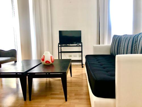 a living room with a couch and a coffee table at Apartamentos de Maria en Martinez! Av Libertador con Patio! in Martínez