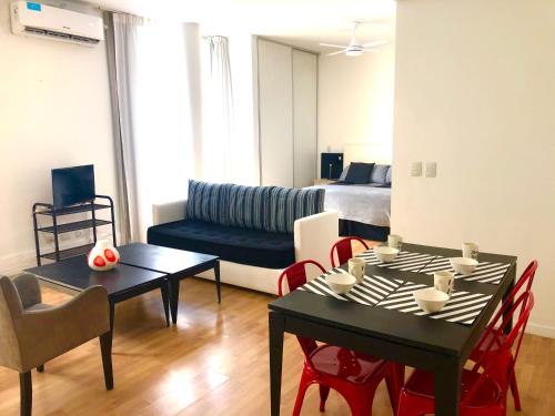 a living room with a couch and a table and chairs at Apartamentos de Maria en Martinez! Av Libertador con Patio! in Martínez