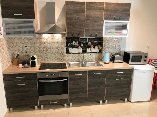 a kitchen with a sink and a stove at Dina's House in Spáta