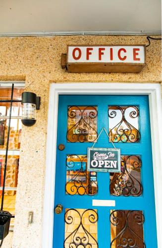 a blue door of a store with a sign above it at Economy Inn Historic District in Saint Augustine