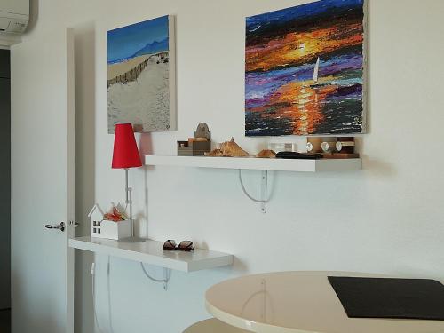 a bathroom with a white tub and a painting on the wall at Beau T2 Climatisé sur Marina avec parking privé in Canet-en-Roussillon