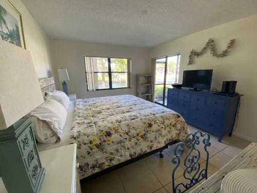 a bedroom with a bed and a dresser and a television at 4330 Shorewalk lakeview condo close to IMG and Beach in Bradenton