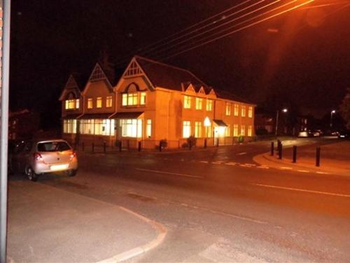 a house with a car parked in front of it at night at Budget Hayat express hotel in Durham