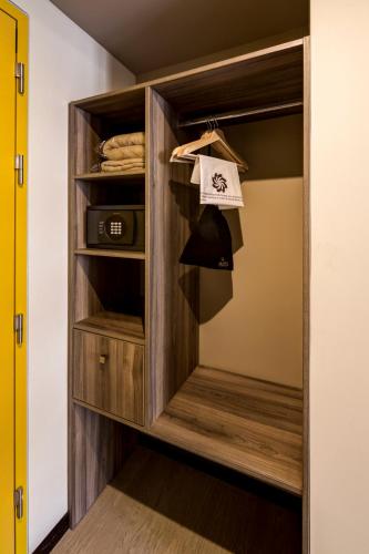 a walk in closet with a wooden cabinet at Arawi Miraflores Express in Lima