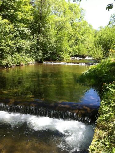 a river with a waterfall in the middle at WISŁA-DOM PRZY RZECE in Wisła