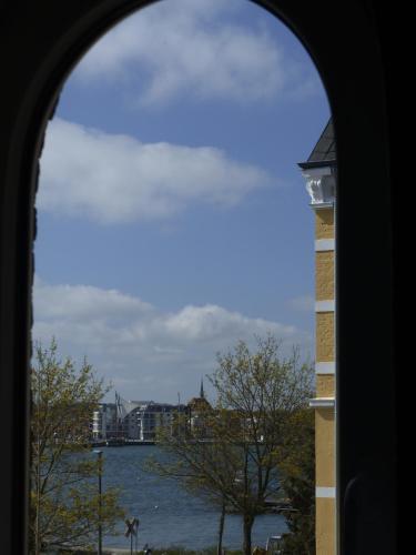 a view of a body of water through a window at Villa Kaethe Borby in Eckernförde
