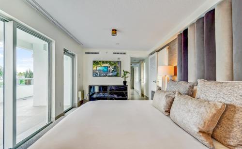 a bedroom with a large bed and a couch at The Sagamore Hotel South Beach in Miami Beach