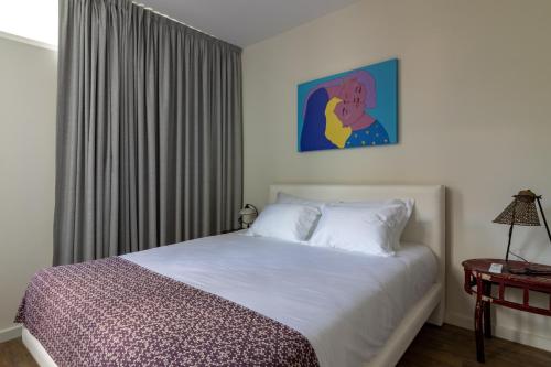Una cama o camas en una habitación de aDuquesa - GuestHouse